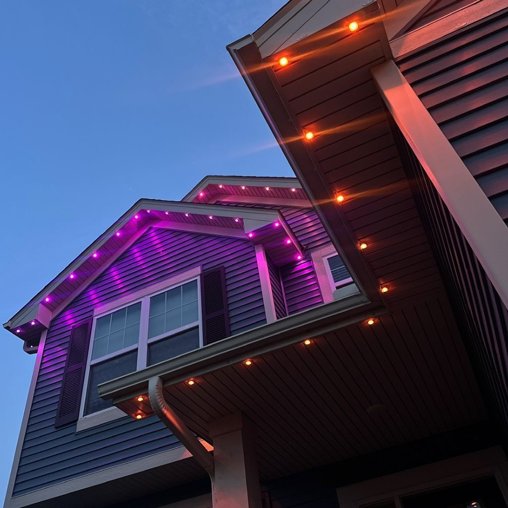 Close-up of purple and amber permanent LED lights along eaves